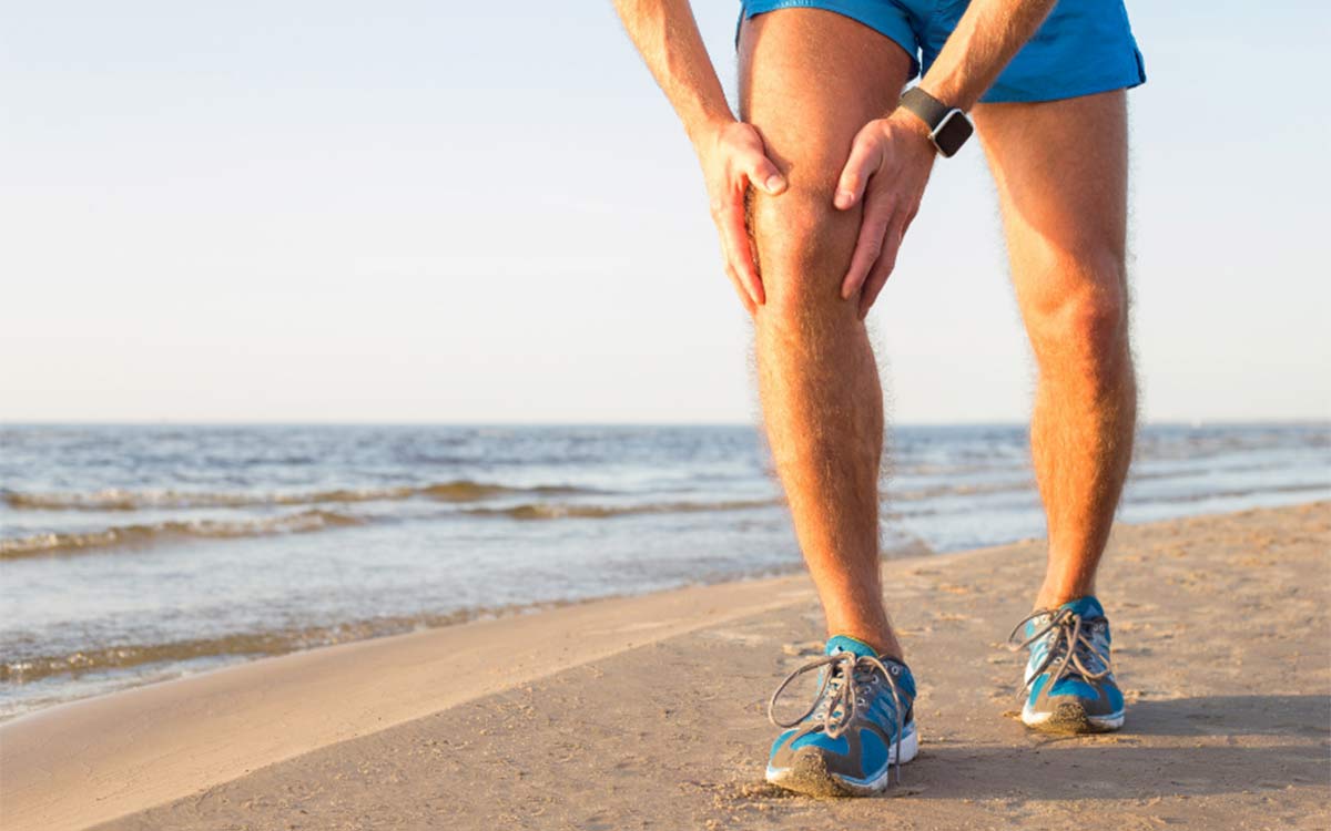 Man with his hands on his knee thinking what should I do if I've torn my ACL.