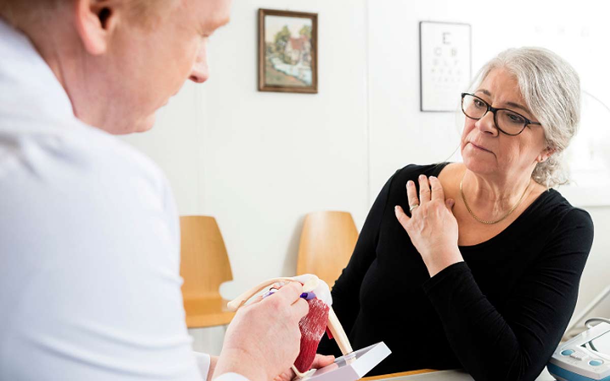 Doctor explaining rotator cuff surgery to a patient.